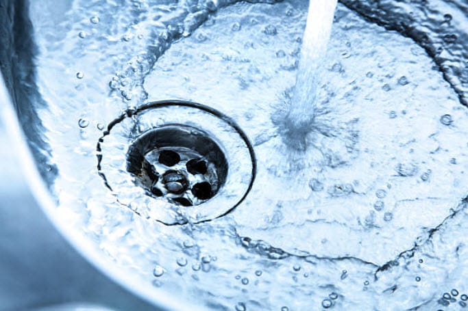 Water draining smoothly down a sink, highlighting effective plumbing maintenance and the role of plumbers in preventing blockages